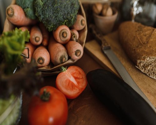 Fresh vegetables and bread on a wooden table in a German kitchen